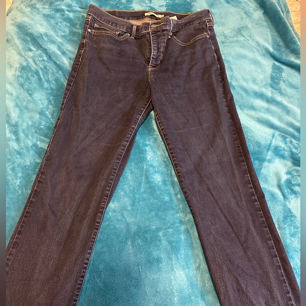 Dark denim stretchy straight legged jeans by Levi Strauss & Co.